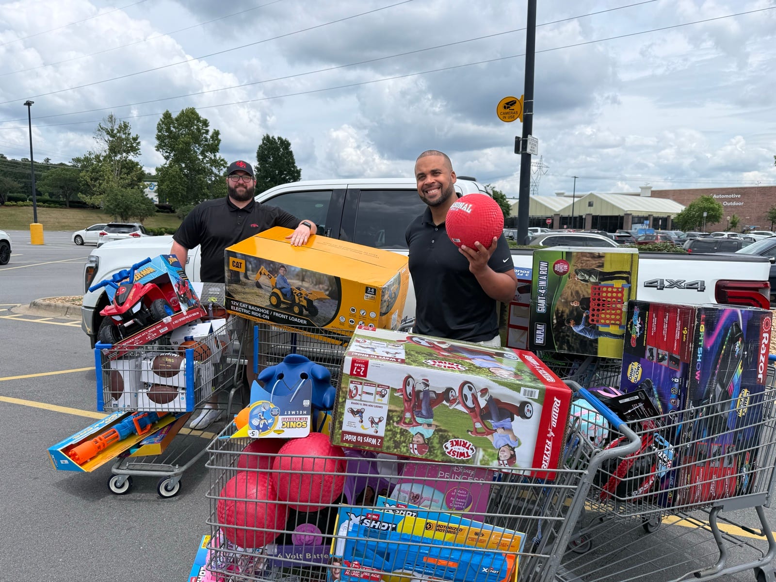 4th & Five crew with carts of donated toys for Women & Children's First